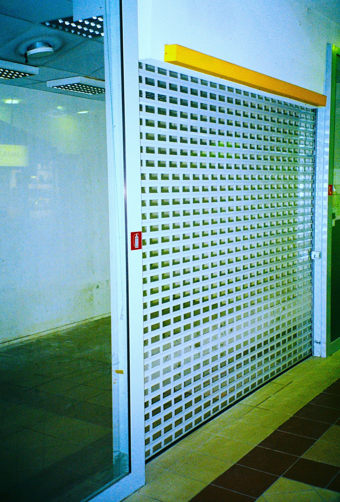 Film-like photo of a white door and textured wall